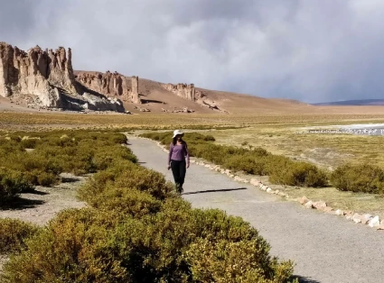 Woman walking in the middle of the desert