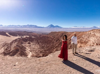 A couple, woman dressed in red and man dressed in white